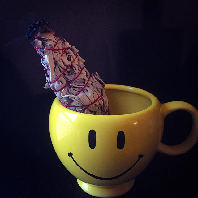 Smiley mug and a sage wand
